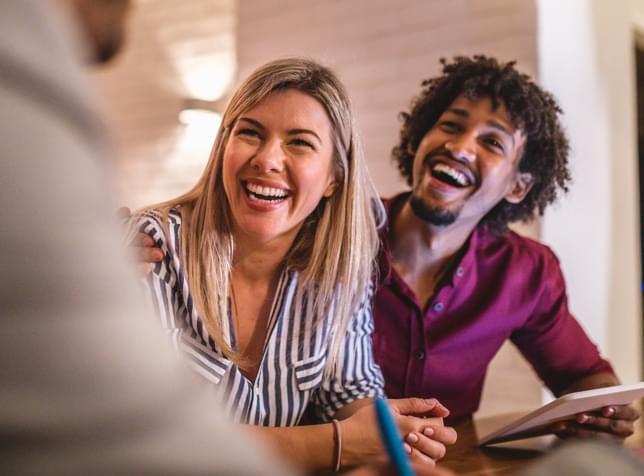 Smiling customers talking a local agent for The General Car Insurance