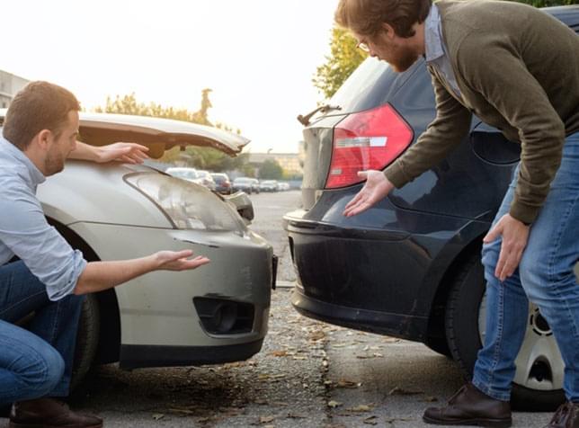 Two people inspecting their cars after a fender bender - The General Insurance Quote Page
